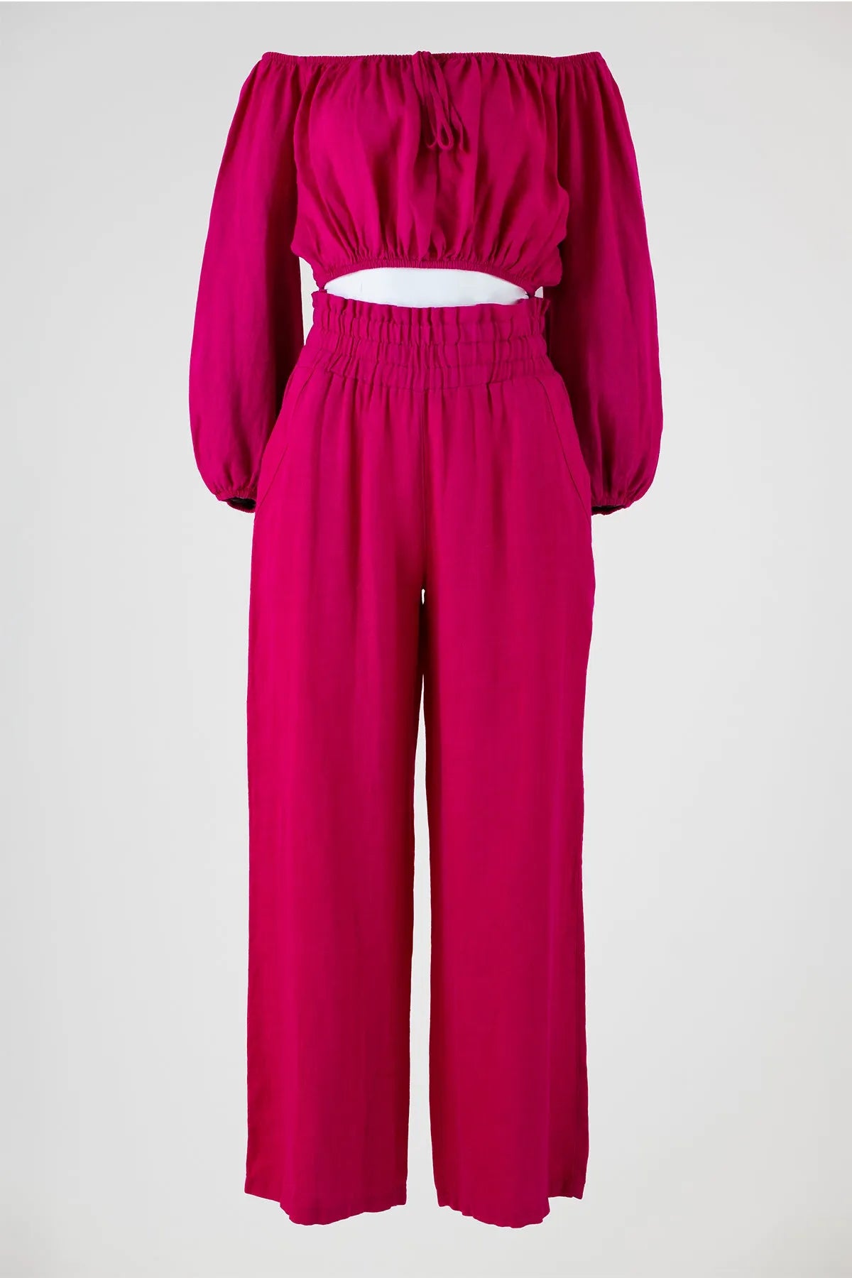 Vibrant fuchsia linen off-shoulder top with puff sleeves and high-waisted wide-leg pants.