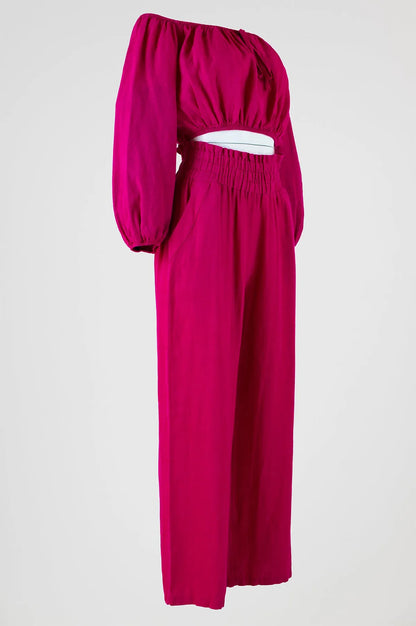 Vibrant fuchsia linen off-shoulder top with puff sleeves and high-waisted wide-leg pants.