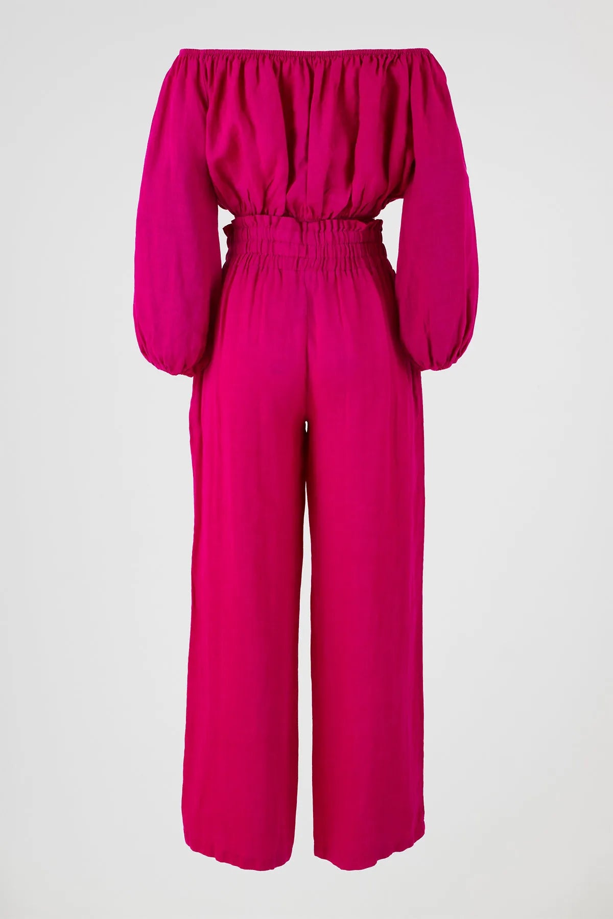 Vibrant fuchsia linen off-shoulder top with puff sleeves and high-waisted wide-leg pants.