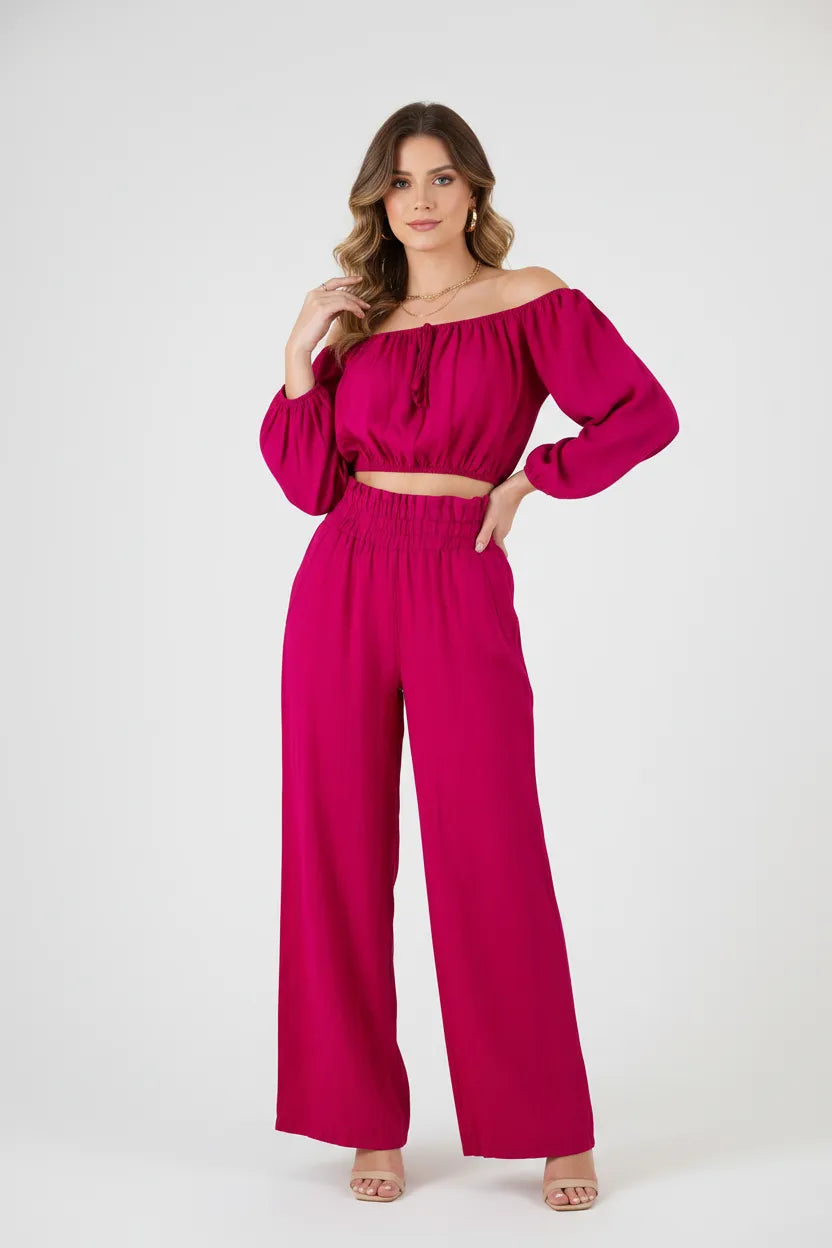 Vibrant fuchsia linen off-shoulder top with puff sleeves and high-waisted wide-leg pants.