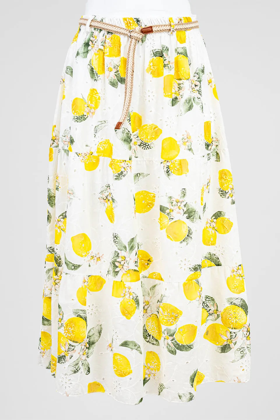 Chic white cotton midi skirt with vibrant lemon print, eyelet embroidery, and braided belt. Perfect summer style.