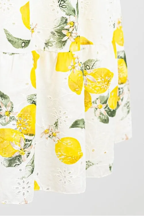White cotton midi skirt with vibrant lemon print and delicate floral eyelet embroidery.