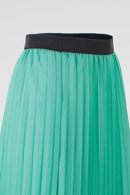 Flowy mint green pleated skirt with a chic black elastic waistband, perfect for effortless style.