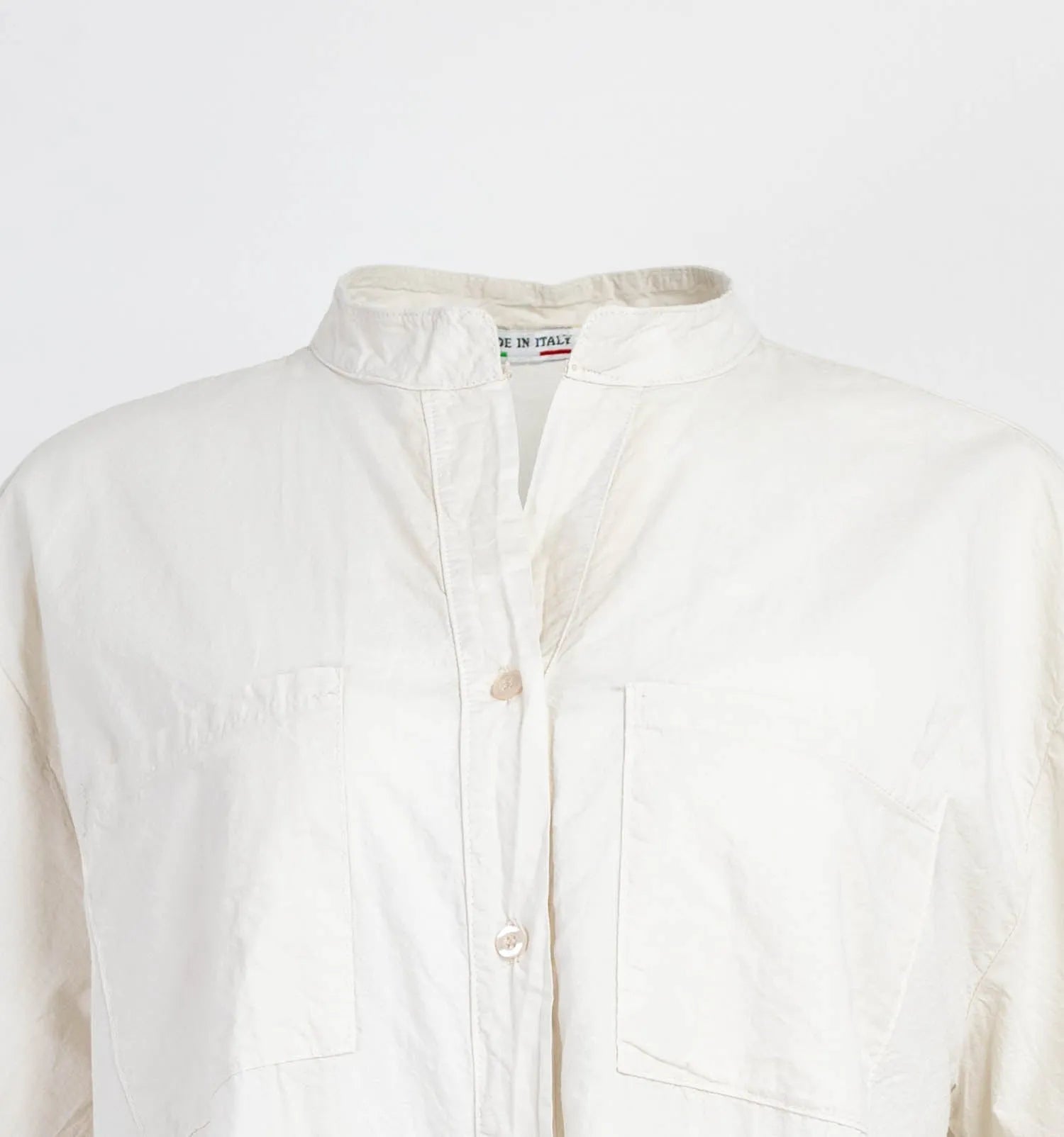 Chic white 100% cotton long shirt with mandarin collar, front buttons, and chest pockets.