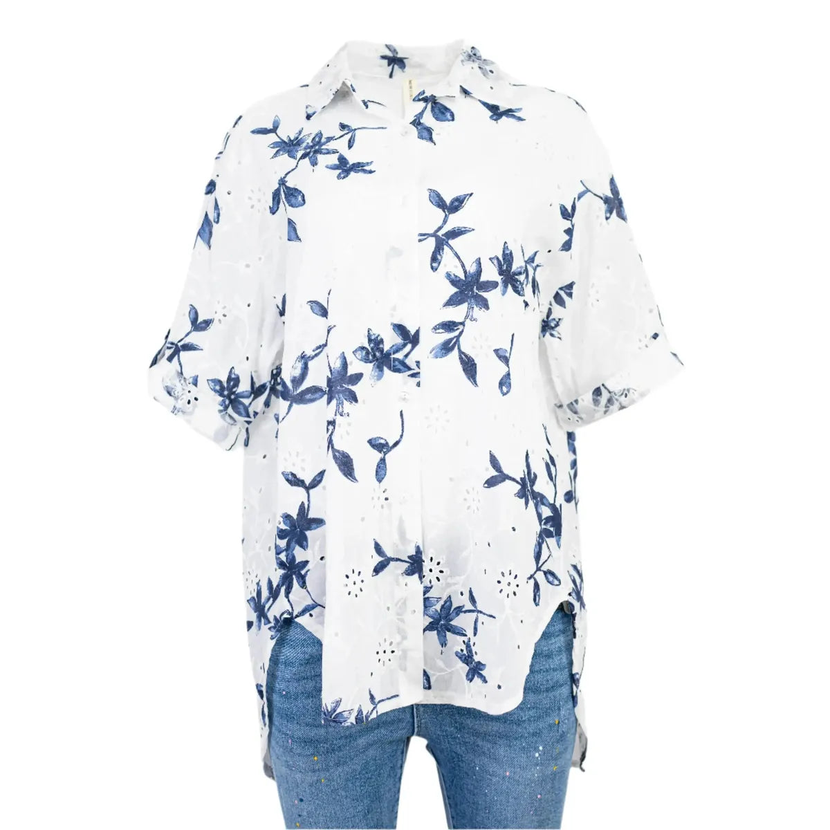 White cotton Sea Whisper shirt with blue floral print, eyelet details, and adjustable sleeves.