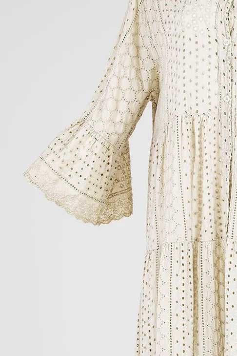 Boho Breeze beige 100% cotton dress with intricate eyelet embroidery, tiered skirt, and flared sleeves.