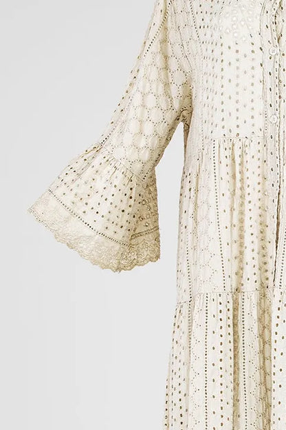 Boho Breeze beige 100% cotton dress with intricate eyelet embroidery, tiered skirt, and flared sleeves.