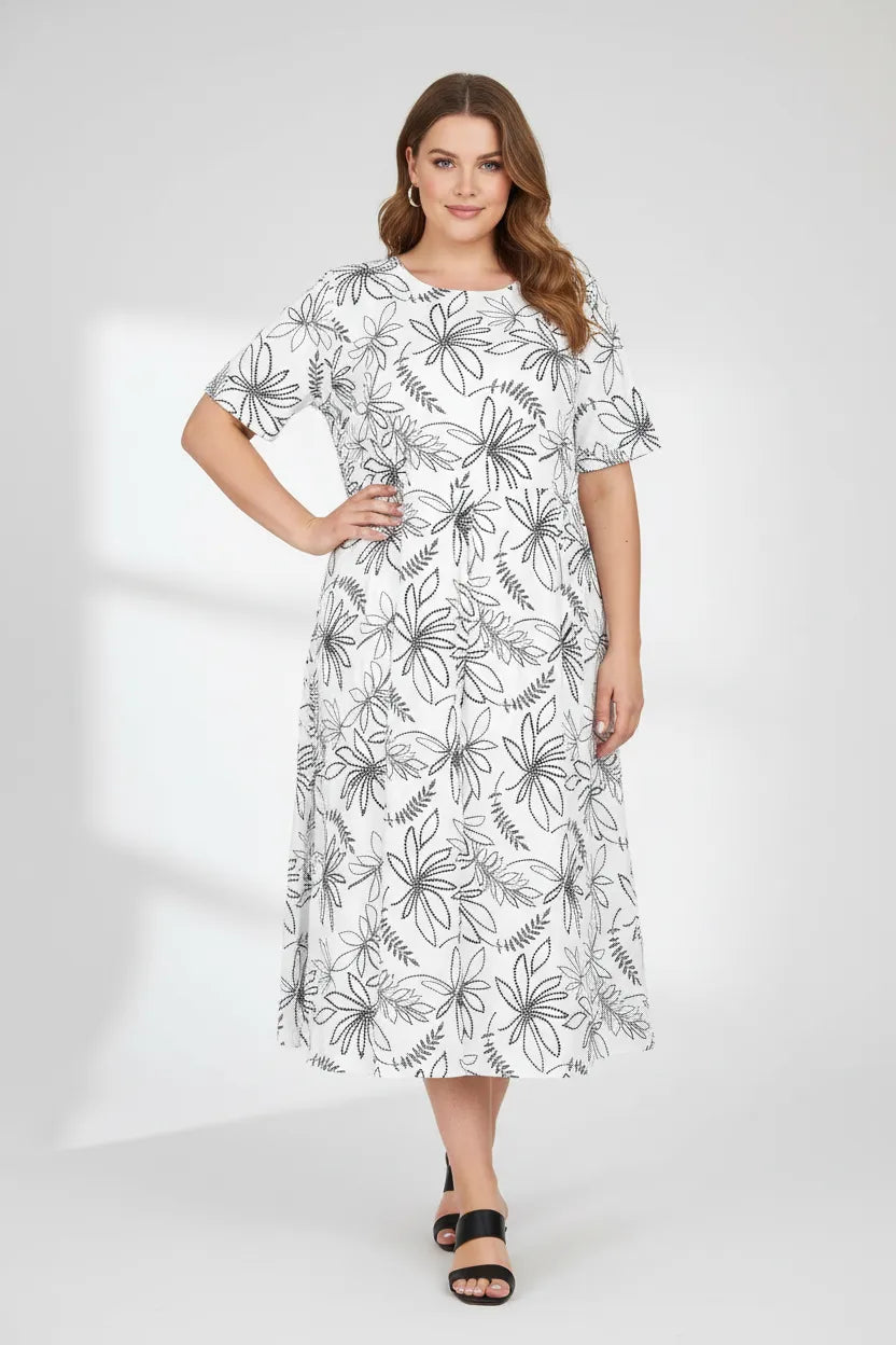 Plus size Flora Flow white dress with blue floral print, short sleeves, and flowing midi length.