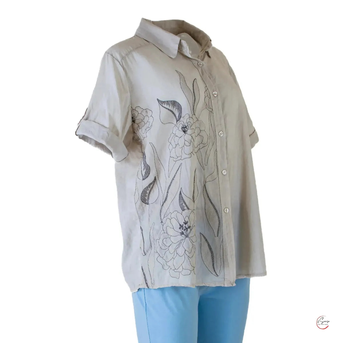 Elegant beige 100% cotton women's shirt with delicate floral embroidery and rolled short sleeves.