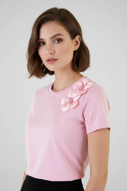 Chic pink women's t-shirt with elegant 3D floral appliques and bead details on the shoulder.