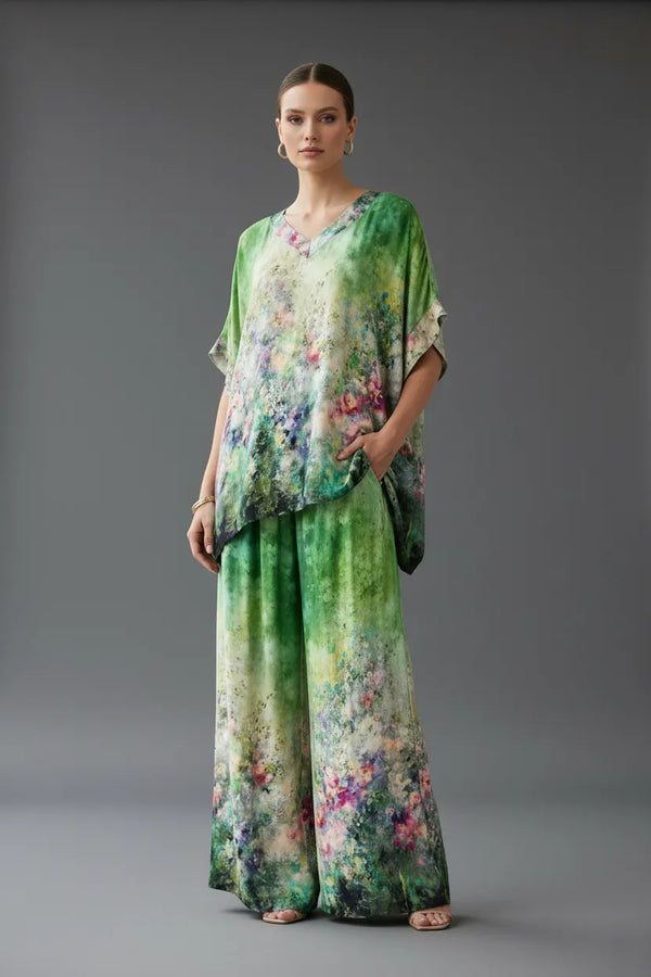 Дамски копринен сет Aurora Muse: топ с V-деколте и широк панталон, с артистичен принт в зелено и пастелни тонове.