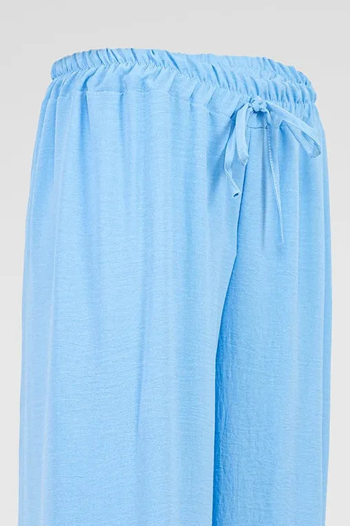 Sky Flow light blue wide-leg summer pants with elastic drawstring waist, soft viscose blend fabric.