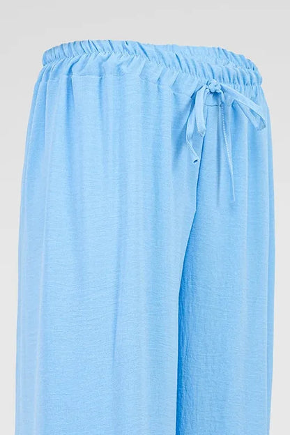 Sky Flow light blue wide-leg summer pants with elastic drawstring waist, soft viscose blend fabric.