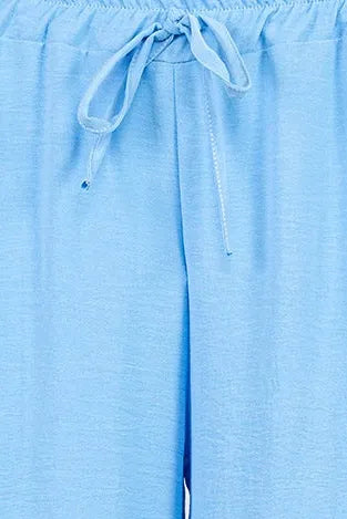 Light blue Sky Flow summer pants with elastic waist and drawstring tie, soft viscose blend.