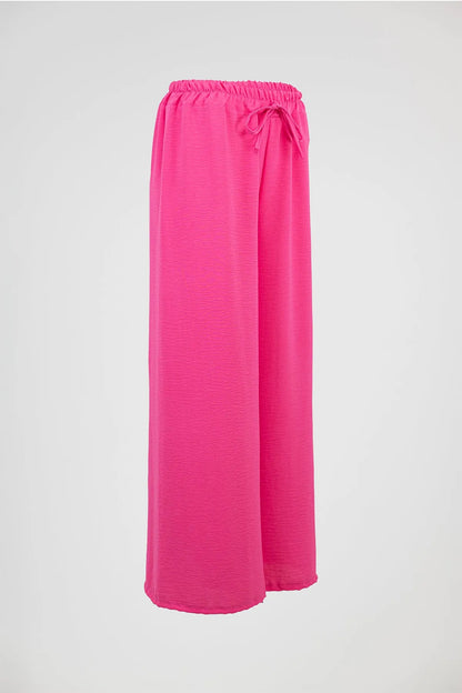 Vibrant pink wide-leg summer pants with elastic drawstring waist, perfect for comfort and style.