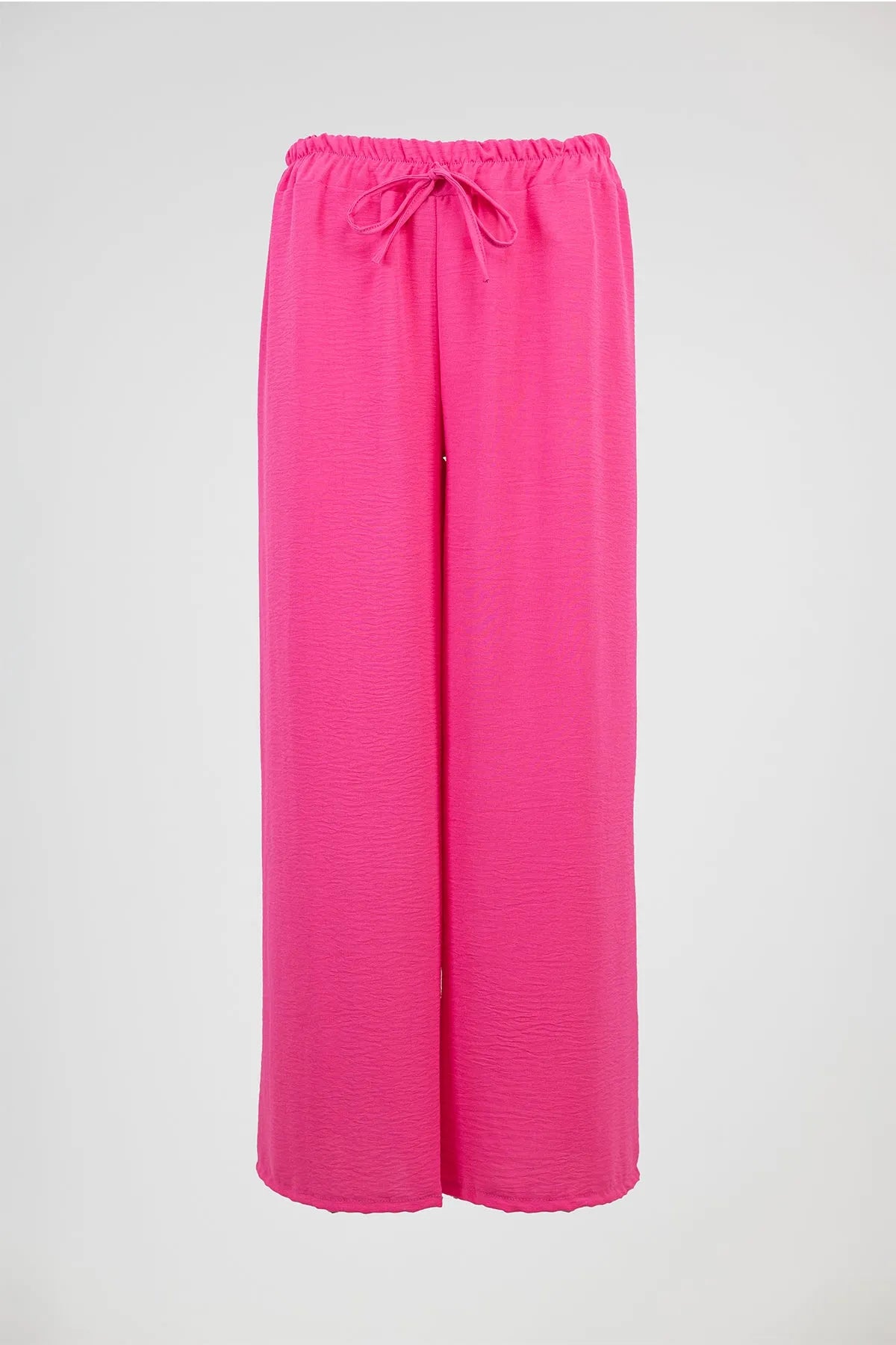 Vibrant pink wide-leg summer pants with an elastic drawstring waist, perfect for comfort and style.