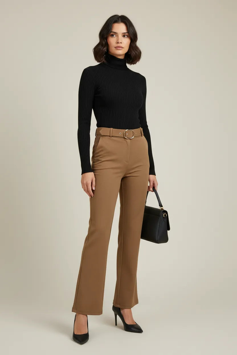 Stylish woman in camel high-waisted trousers with belt, black turtleneck, heels, and handbag.