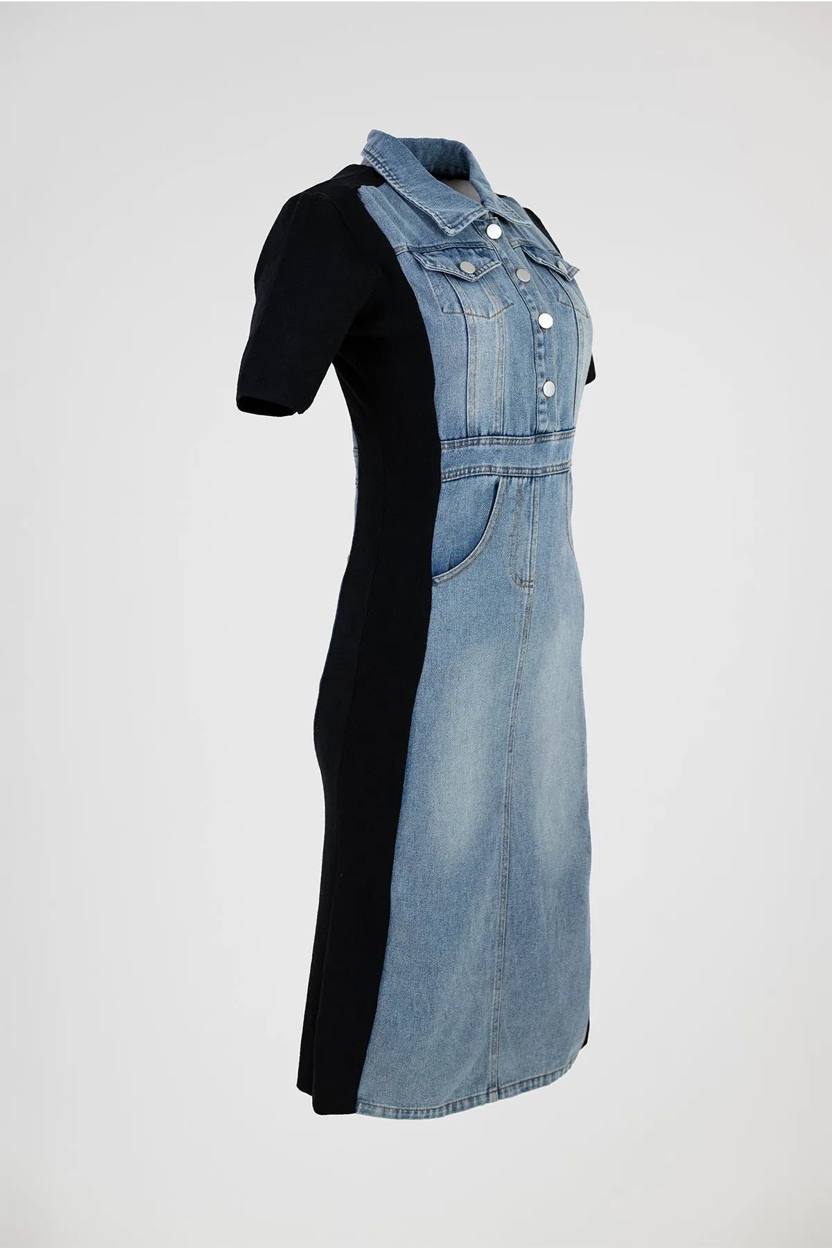 Stylish denim midi dress with black elastic side panels, metal buttons, and pockets, offering a flattering silhouette.