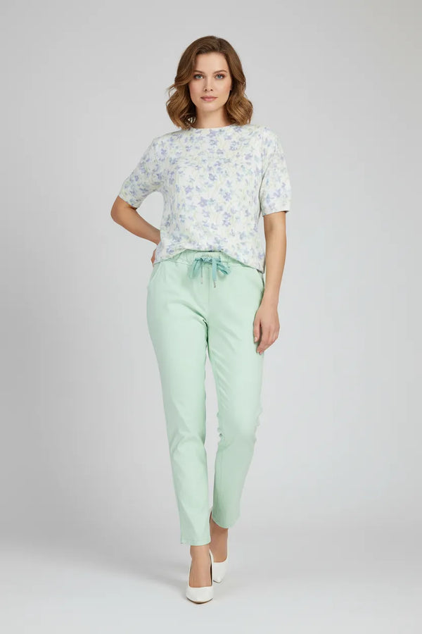 Стилна жена с мента панталон и флорална блуза